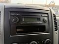 The dashboard of a 2012 Mercedes-Benz Sprinter featuring a radio control panel and air conditioning dials