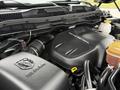 Close-up of the engine compartment of a 2018 RAM 1500 featuring an EcoDiesel engine with visible components like the engine cover and various hoses