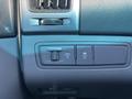 Close-up of a control panel in a 2014 Hyundai Sonata featuring switches for various functions and indicator lights