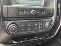 Dashboard controls of a 2016 Chevrolet Silverado 2500HD featuring audio and climate controls with knobs and buttons