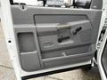 Interior door panel of a 2008 Sterling Bullet featuring a gray finish with a handle a speaker grill and controls for window adjustments