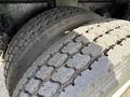 Close-up of two worn tires from a 2008 Kenworth T370 showing tread patterns and sidewalls
