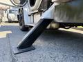 A black metal step extending from the side of a 2010 Freightliner M2 106 truck