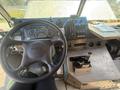 The interior dashboard of a 2009 Workhorse W62 showing the steering wheel gauges control panel and gear shift lever
