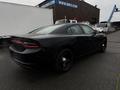 A black 2017 Dodge Charger parked with a sleek design featuring a distinctive rear tail light and dark rims