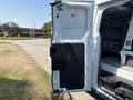 A 2019 Ford Transit 350 with the sliding side door open showcasing the interior and cargo space