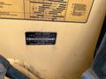A 2012 John Deere 310SJ backhoe loader featuring a metal identification plate with product information and a serial number