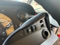 Close-up of the gear shift lever and dashboard controls in a 2018 Ford Econoline showing gauges and various switches