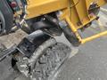 A 2014 Vermeer Corporation Sweep Stump Cutter featuring a rugged tire and metal frame with visible wear and tear marks