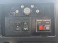The image shows the control panel of a 2013 International DuraStar 4300 featuring switches for lights and driver control labeled left and right