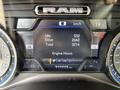Dashboard of a 2021 RAM 1500 showing speedometer, fuel range, and engine hours with illuminated indicators and digital display