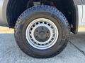 A close-up of a silver wheel and tire of a 2024 Mercedes-Benz Sprinter 2500 featuring an alloy rim and an all-terrain tire with the brand name visible