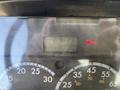 Dashboard display of a 2014 Freightliner M2 106 showing hours and a brake warning light