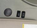 Interior control panel of a 2014 Chevrolet Express featuring buttons for adjusting a sign marked up and down and a circular magnet or cover