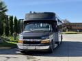 A 2019 Chevrolet Express bus with a black front and white body featuring multiple windows and a prominent Chevrolet logo on the grille