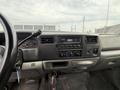Interior view of a 2004 Ford F-350 SD dashboard featuring controls for the audio system and air conditioning along with various knobs and gauges