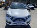 A 2018 Hyundai Santa Fe in white with a distinctive front grille and sleek headlights