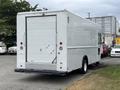 A white 2018 Ford Econoline cargo van with a closed rear door and no windows on the sides