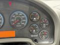 Dashboard of a 2013 International Workstar 7500 showing speedometer fuel gauge voltmeter and various warning lights
