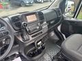 Interior view of a 2023 RAM Promaster 3500 showing the dashboard with infotainment screen gear shift and driver's seat