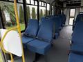 Interior of a 2013 Chevrolet Express with blue upholstered seats and seatbelts arranged in rows