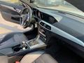 Interior view of a 2013 Mercedes-Benz C-Class featuring a modern dashboard gear shift and leather upholstery