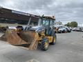 A 2012 John Deere 310SJ backhoe loader with a bucket attachment in the foreground