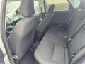 A 2018 Ford Focus with a black interior featuring a rear seating area that includes two seats with seatbelts and a partially folded back seat for additional space