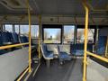 Interior view of a 2016 Grande West Vicinity bus featuring blue upholstered seats and yellow handrails