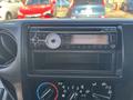 Dashboard of a 2018 Hino 195 featuring a Clarion car stereo with Bluetooth controls and air conditioning knobs below it