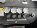 A dashboard featuring pressure gauges and control knobs from a 2012 International DuraStar 4300 truck