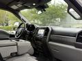 Interior view of a 2020 Ford F-550 showing dashboard seats and center console with infotainment system