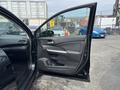 A 2014 Honda CR-V with the driver's side door open showing the interior door panel and controls