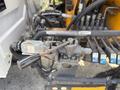 A close-up of the hydraulic control valve assembly from a 2011 International 4300 with various hoses and connectors attached