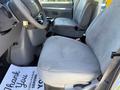 Interior view of a 2006 Ford Econoline showing the driver's seat and dashboard with a gray fabric seat and steering wheel