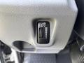 A control button with a sun icon and a slider gauge on a textured gray surface