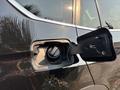 A close-up of the fuel filler cap of a 2013 BMW X3 with the cap partially removed