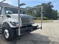 A 2012 International 7300 Workstar truck with a prominent front grill and a mounted ladder rack extending from the cab
