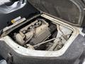 Engine compartment of a 2008 Suzuki Carry showing a grey engine with various components and wiring visible