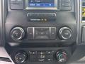 Dashboard controls of a 2020 Ford F-150 featuring audio and climate controls with buttons and knobs