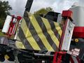 A 2020 Pottinger Impress with a yellow and black striped warning flag attached to its side