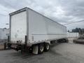 A 2010 Great Dane 45-foot trailer with a white exterior backed into a parking spot showing wheels and rear lights