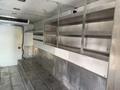 A 2017 Freightliner MT45 interior with metal shelving and a diamond plate floor designed for cargo storage and organization