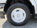 Close-up of a white wheel and tire from a 2021 Ford Econoline van showing the rim and tread details