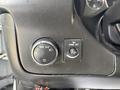 Dashboard controls of a 2020 Chevrolet Express featuring a headlight switch and a dome light switch