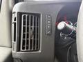 Close-up of the dashboard controls and air vent in a 2019 Chevrolet Express showing buttons for lights and hazard signals