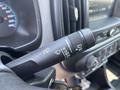A close-up of the windshield wiper control stalk in a 2017 Chevrolet Colorado displaying settings for wipers and headlights