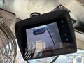 A monitor displaying a rear view of a 2012 Ford Econoline van parked outdoors
