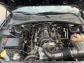 The engine compartment of a 2019 Dodge Charger showing the V8 engine with various components and wiring visible