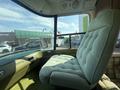 A vintage 1976 GMC Motorhome driver's seat upholstered in light green fabric with a plush cushion and a high backrest
